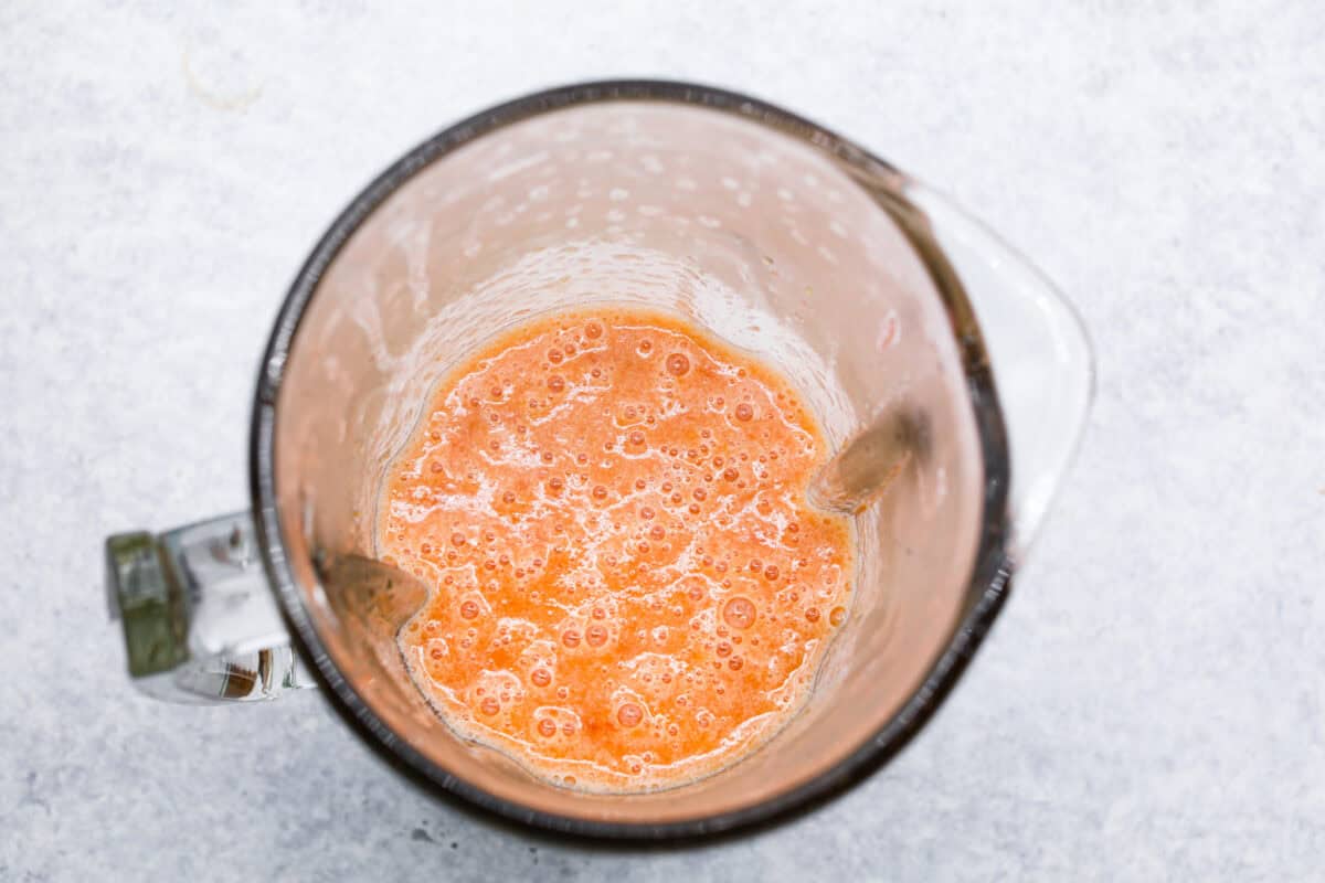 This is the absolute BEST fresh peach lemonade recipe! Sweet juicy peaches combined with tart, tangy lemons make the most refreshing drink. You will want to have a pitcher of this in your fridge throughout the peach season! Overhead shot of blended peach mixture.